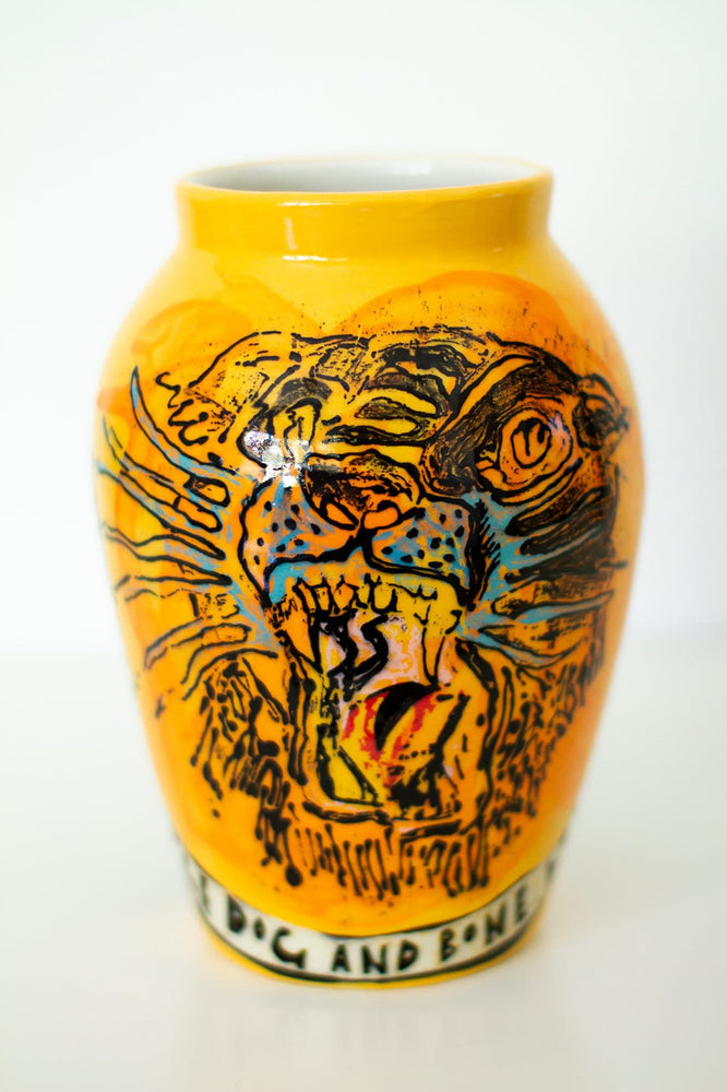 Yellow ceramic vase decorated with a hand painted image of a tiger's face