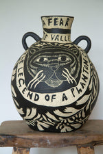 Large ceramic pot decorated with a black and white sgraffito design of a tigers's face